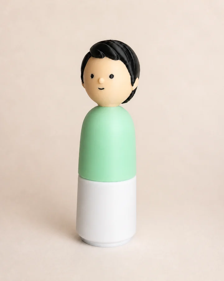 Light-skinned 3D-printed figure with black hair, a mint-green top and a white base, showing fine printed layers